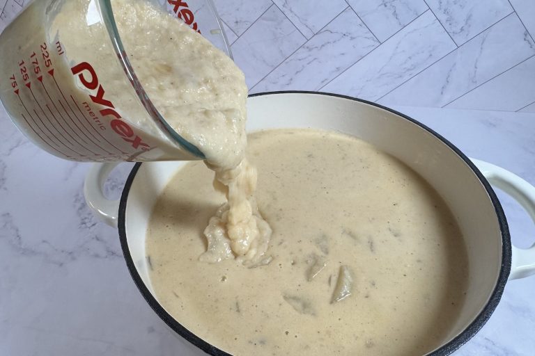 Pouring blended soup back into a pot to make soup creamy without cream